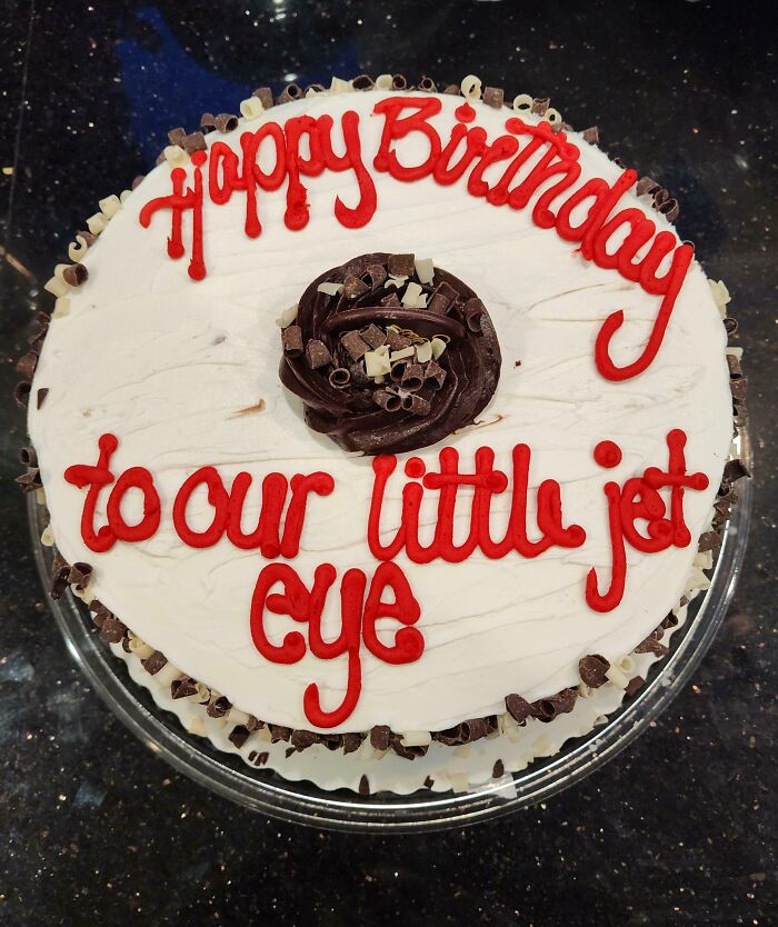 Cake with "Happy Birthday to our little jet eye" written, showcasing hilarious misunderstandings.