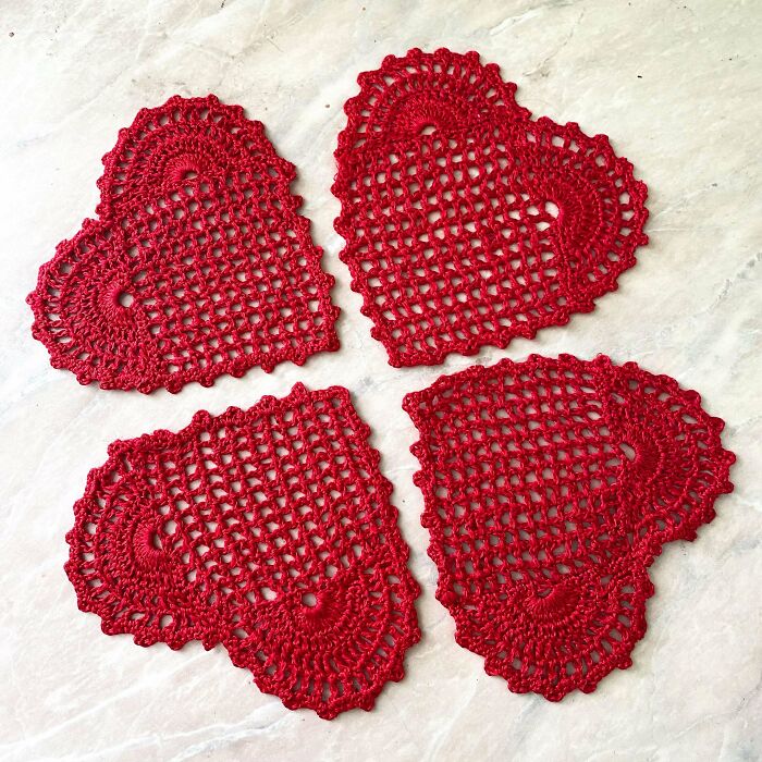 Red heart-shaped crochet doilies, perfect Valentine’s Day gift inspiration.