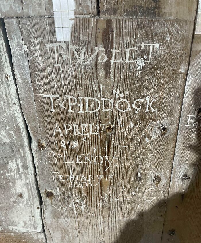 Engraved wooden panel showcasing historical names and dates, exemplifying cool-old-things.