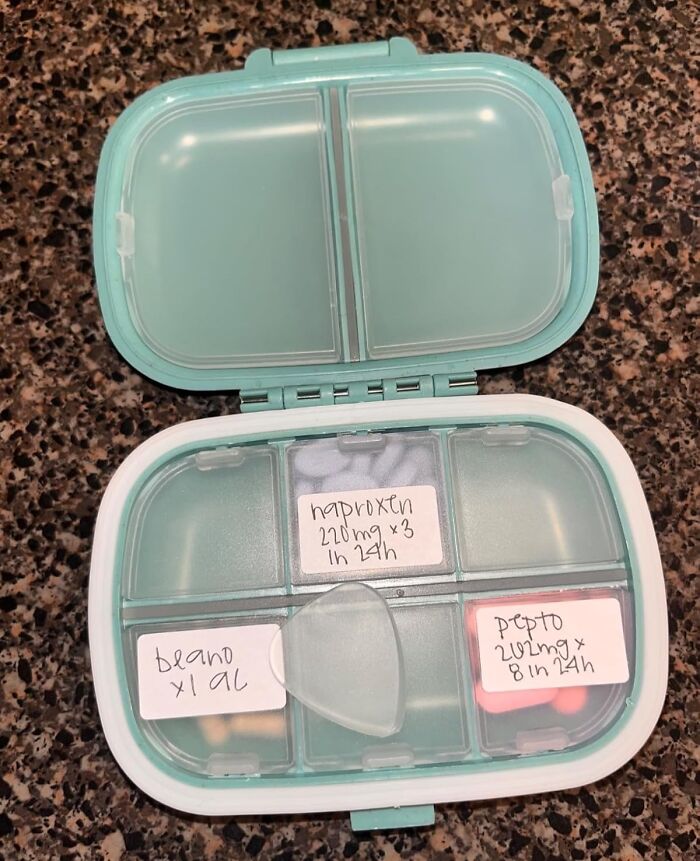 Pill container with medication labeled naproxen, Beano, and Pepto, showcasing cult favorites for health routines.