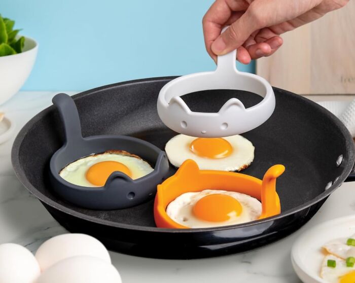 Eggs cooking in a pan with panda-shaped molds, showcasing cult favorites.