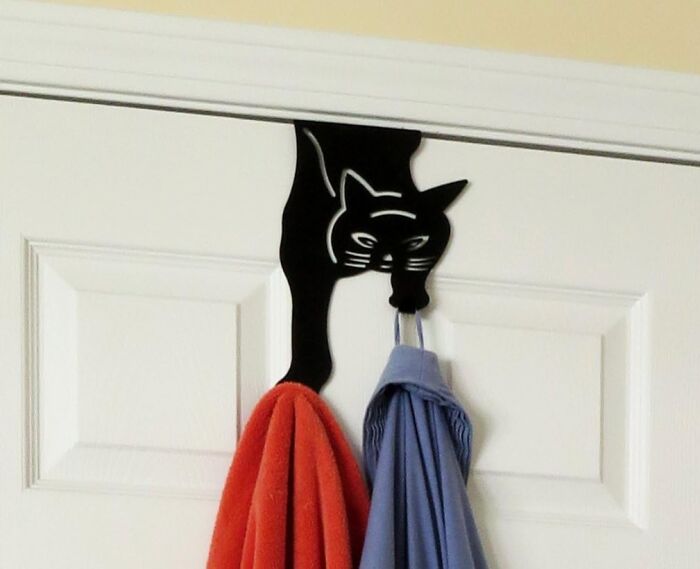 Cat-shaped door hook holding robes, showcasing cult favorites that have gained immense popularity.