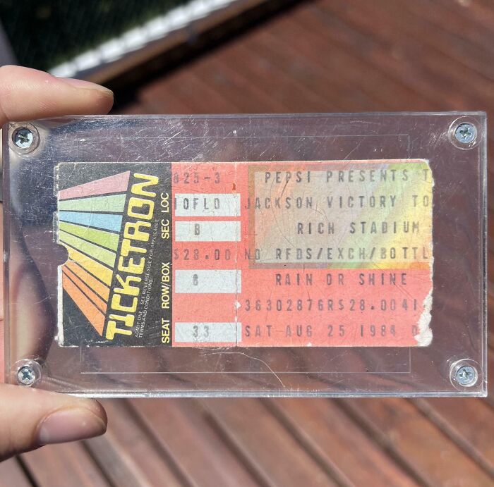 Vintage concert ticket from 1984, part of Cool-Old-Things collection, encased in a clear plastic frame.