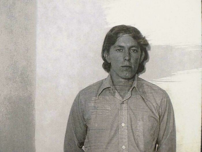 A person posing for a photo in a buttoned shirt, sharing an interesting fact.