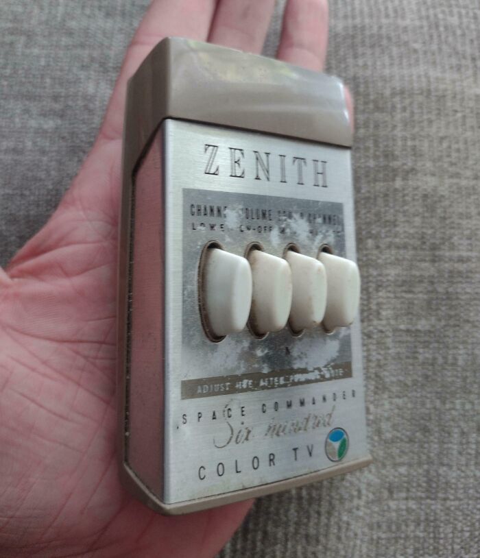 Vintage Zenith TV remote with white buttons; a prime example of cool-old-things, resting in a person's hand.
