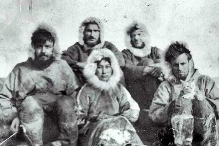 Five explorers in fur-lined coats seated together, evoking historical adventure and interesting facts.