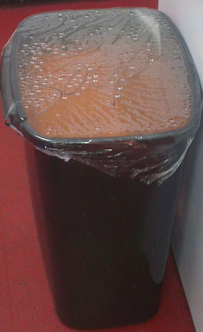 "Trash bin filled with a mystery red liquid, illustrating budget wedding fails in catering or decoration mishaps."