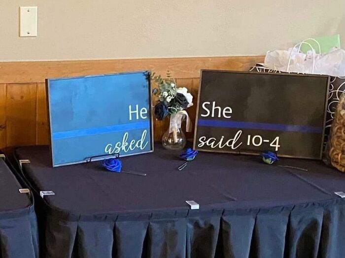 Signs at a wedding with slogans "He asked" and "She said 10-4," showcasing budget wedding fails humor.