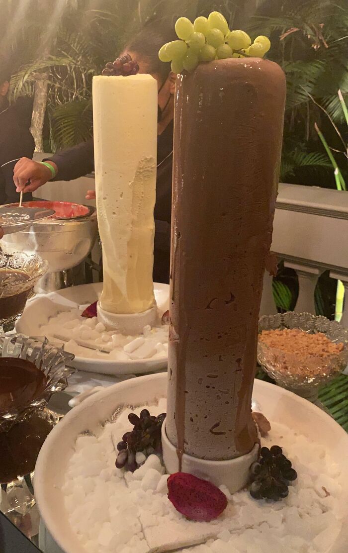 Tall chocolate and vanilla desserts melting at a wedding reception with fruit garnish, illustrating budget-wedding fails.