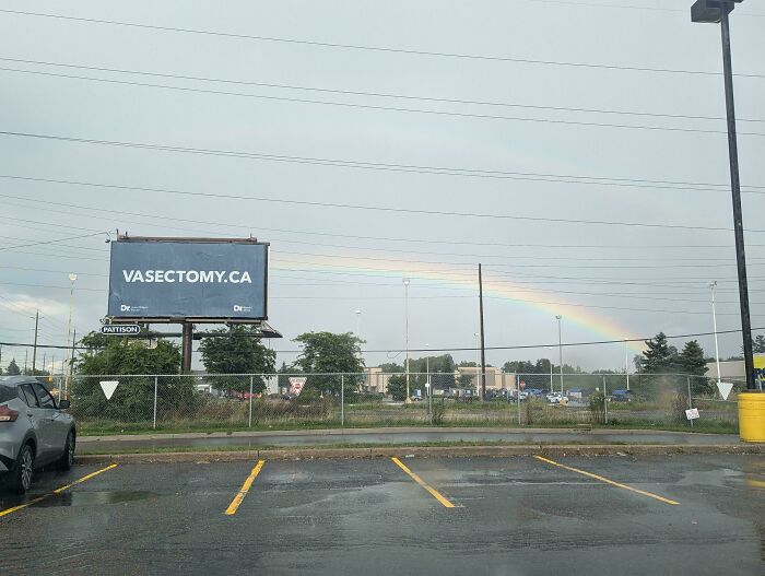 Billboard for vasectomy with a rainbow in the background, representing funny signs and billboards.