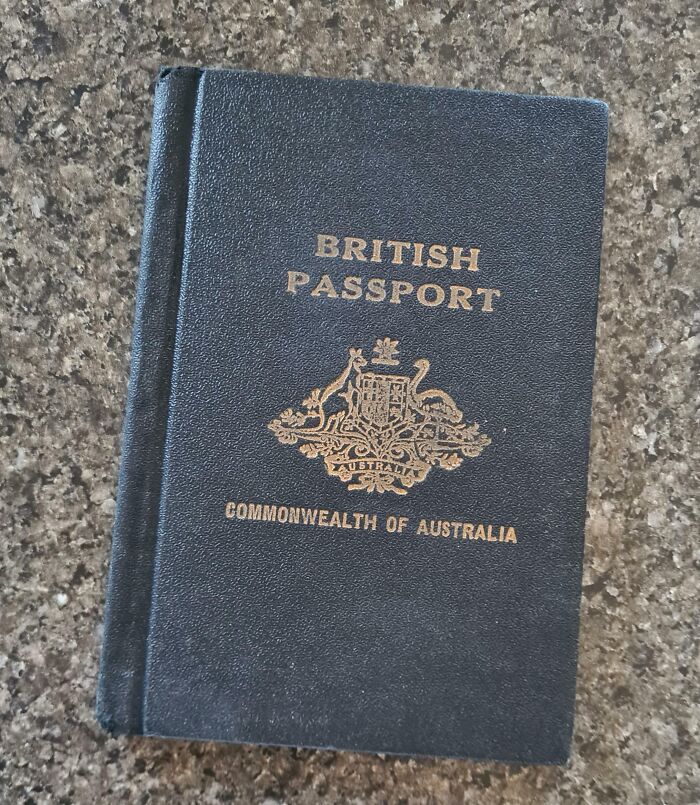 Cool-old-things: Vintage British passport from the Commonwealth of Australia on a stone surface.
