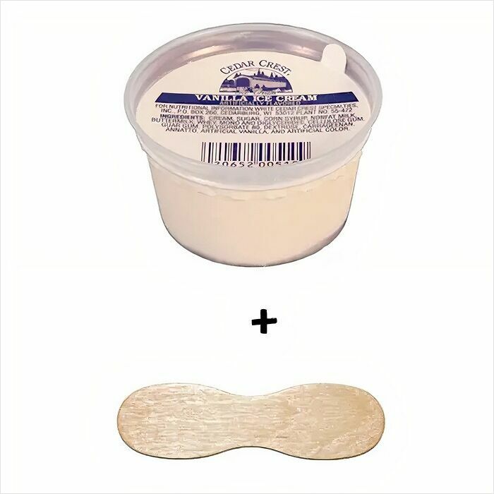 Cup of vanilla ice cream with a wooden spoon, evoking old-school memories.