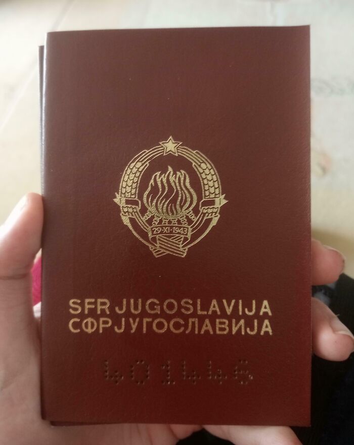 A vintage Yugoslavian passport being held, featuring emblem and text, representing cool-old-things.