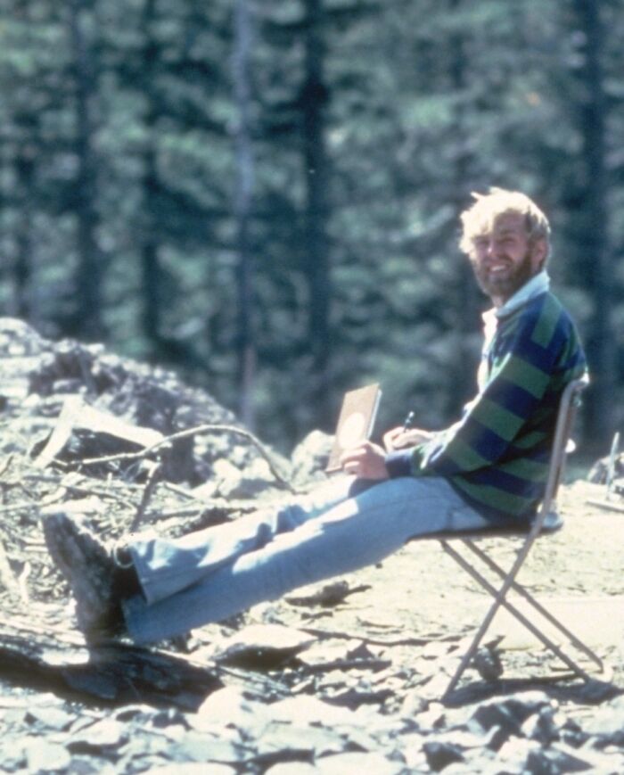 Man in a striped sweater sitting outdoors, linked to photographs with terrifying backstories.