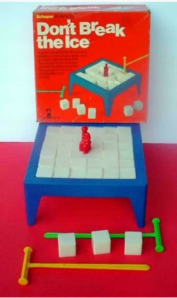 Vintage "Don't Break the Ice" game set, featuring red and yellow mallets, on a red background.