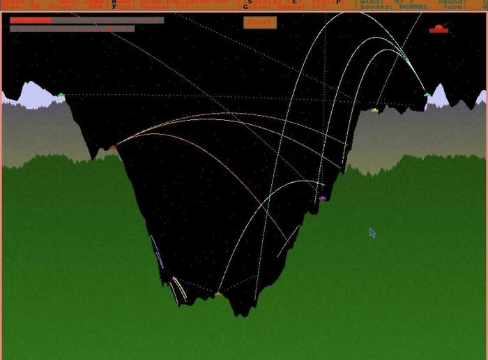 A '90s computer game screenshot showing projectile paths over a pixelated landscape.