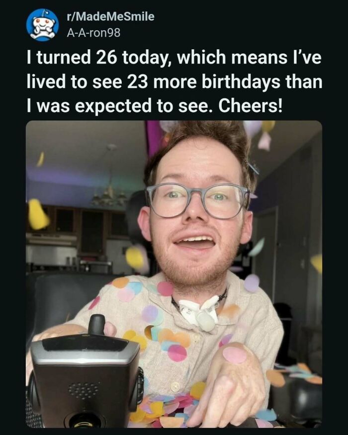 Man celebrating 26th birthday surrounded by colorful confetti, bringing positive vibes to your day.