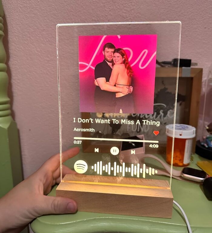 Personalized music plaque for long term couples, featuring a romantic photo and song details on a wooden base.