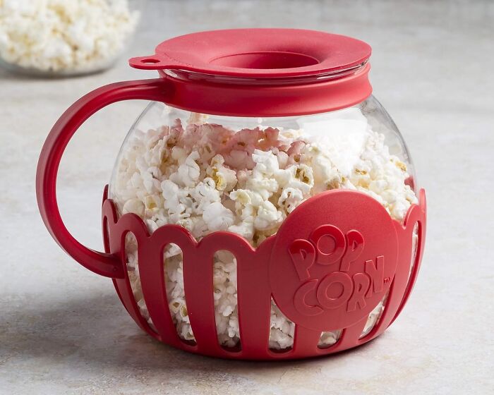 Red popcorn bowl filled with popcorn, perfect for long term couples' movie nights.