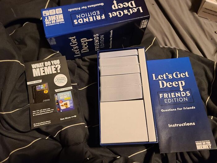 "Let's Get Deep card game on bed, ideal for long term couples to deepen connections."