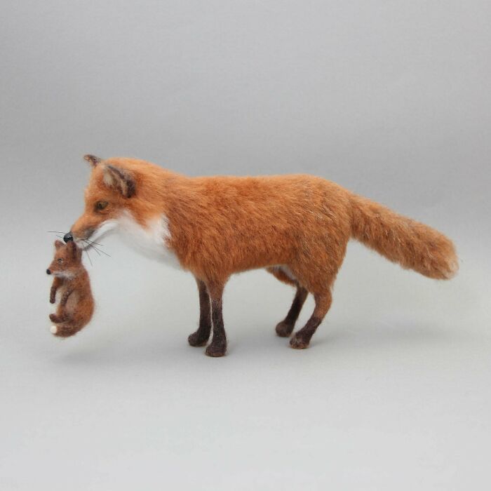 Realistic DIY felt fox and cub sculpture.
