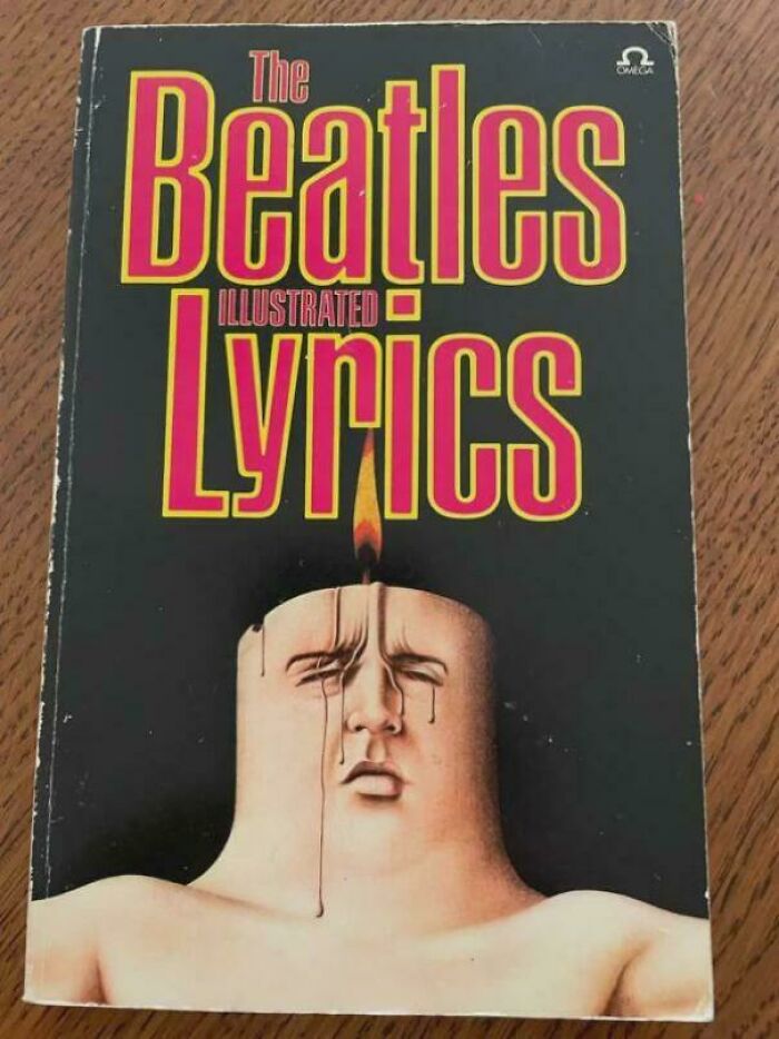 Terrible book cover of "The Beatles Illustrated Lyrics" featuring a surreal candle-headed figure.