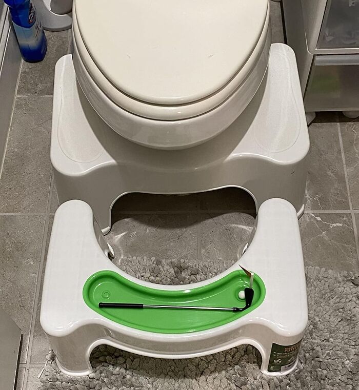 Toilet with a white step stool and a green tray, showcasing a clever impulse buy decision.
