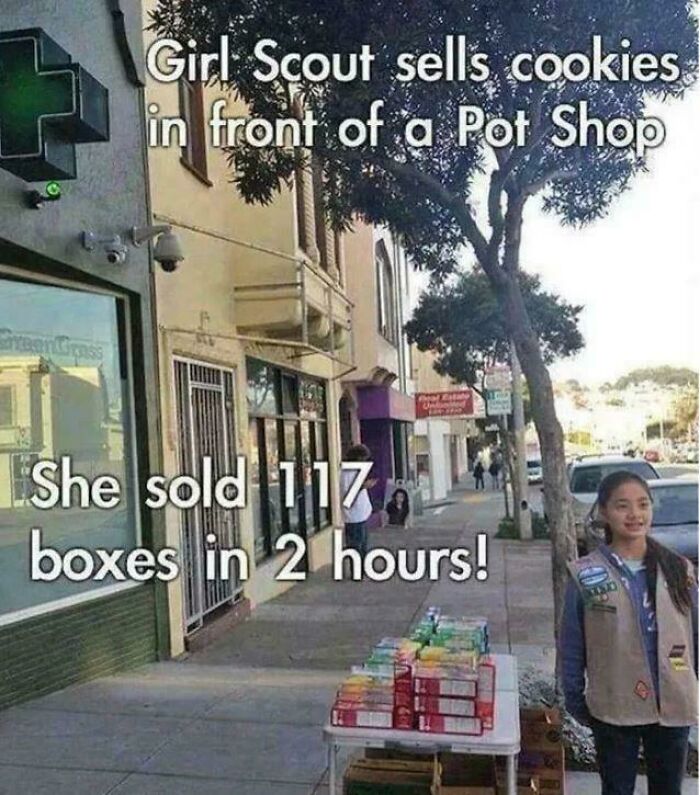 Girl Scout sells cookies outside shop; a strange and funny scene with 117 boxes sold in 2 hours.