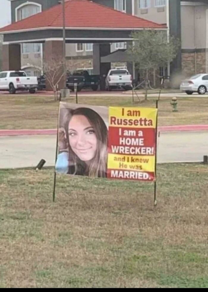 Sign in a yard with a large photo and dramatic text, highlighting strange and funny community activities.