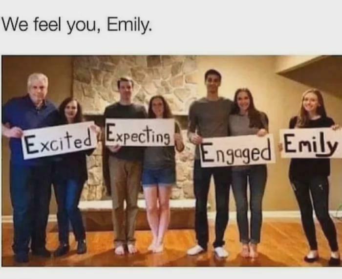 Group holding signs reading "Excited," "Expecting," "Engaged," and "Emily," for a funny community meme.