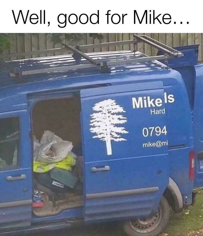 Blue van with humorous sign reading "Mike Is Hard" parked with open door, showcasing funny community's quirky content.