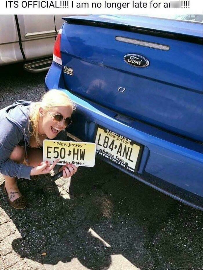 A person holding a removed New Jersey license plate next to a car with another plate, depicting a funny situation.