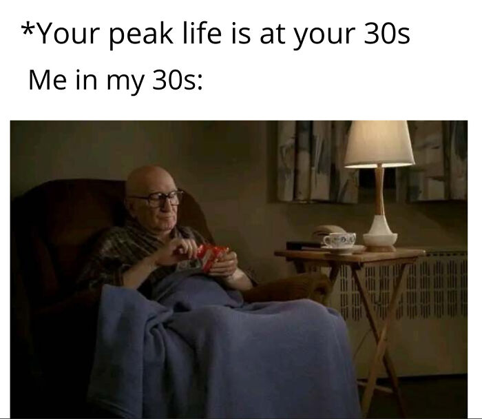 Elderly man in armchair with snacks under a blanket, showcasing strange and funny moments in life.