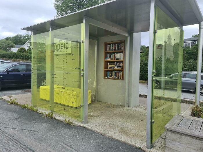 Urban bus stop with bookshelves, showcasing Cities-Genius-Solutions through creative public space design.