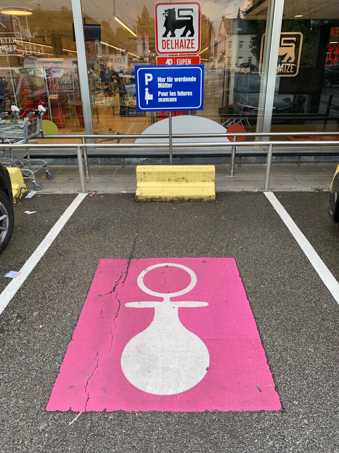 Parking space in front of a store marked with pink pacifier symbol, showcasing Cities-Genius-Solutions for expectant mothers.