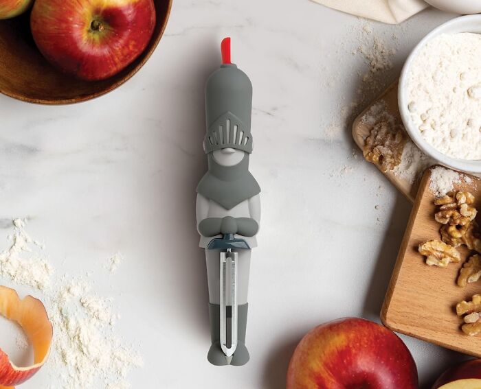 Knight-themed peeler amidst kitchen items, showcasing weird kitchen gadgets that work well.