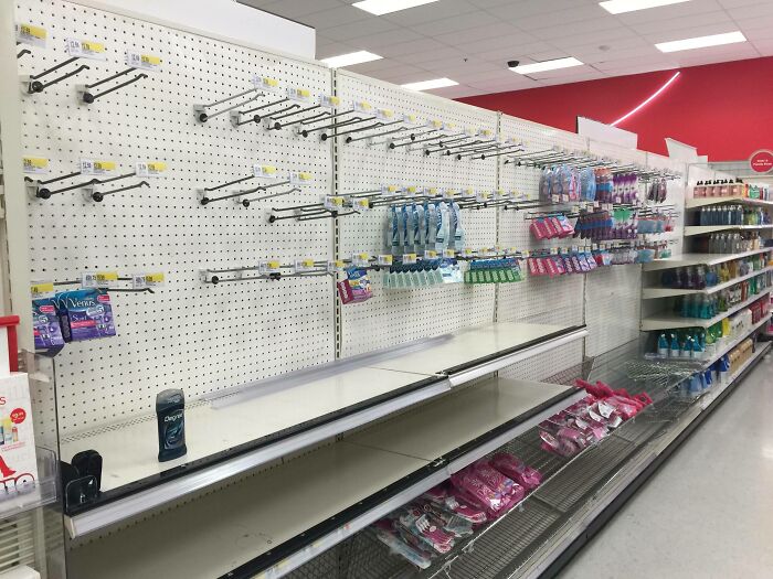 Empty store shelves with a few scattered Valentine's gifts displayed.