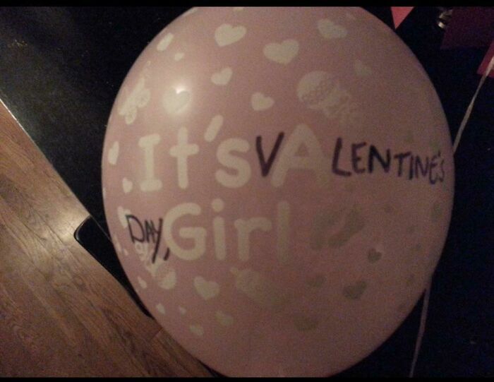 Valentine's Day pink balloon with hearts, featuring a quirky message, adds a weird yet cute touch.