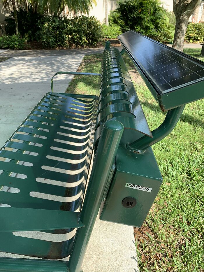 Solar-powered bench with USB ports, showcasing Cities-Genius-Solutions for urban outdoor spaces.