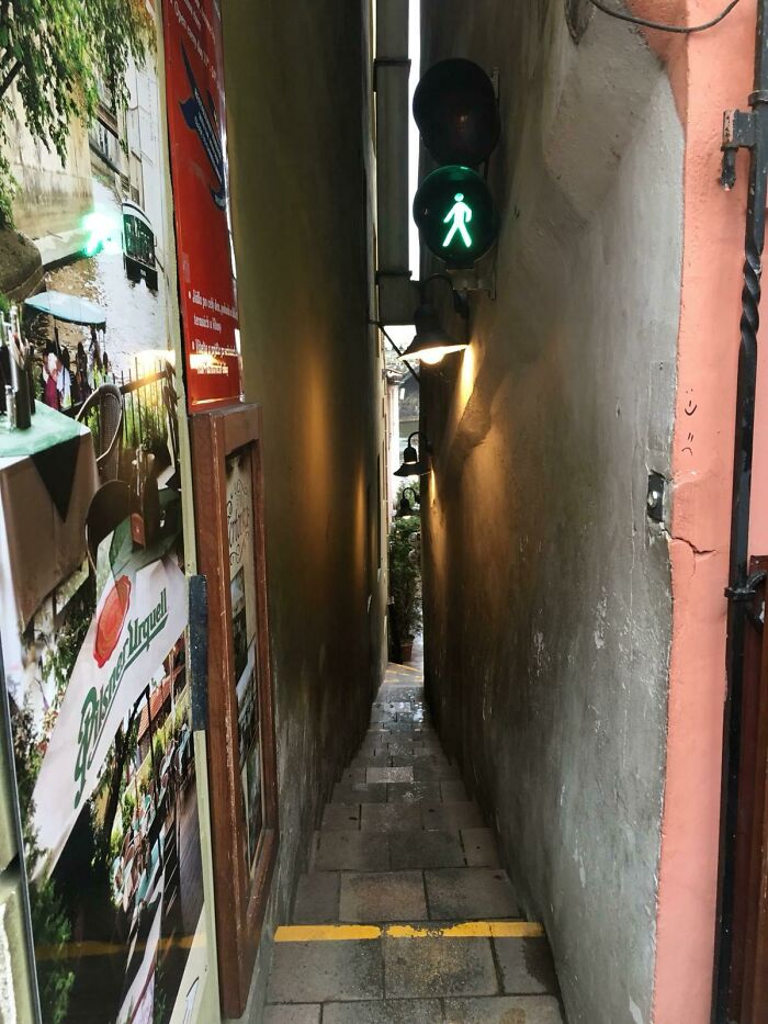 Narrow alley with traffic light, showcasing urban Cities-Genius-Solutions.