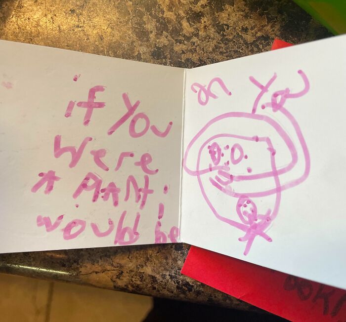 Child's handwritten Valentine's card with a cute doodle and pink ink, expressing an imaginative message.