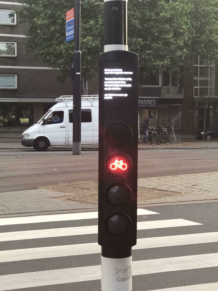 Traffic light with red bicycle signal, innovative urban solution in city setting, showcasing cities-genius-solutions.