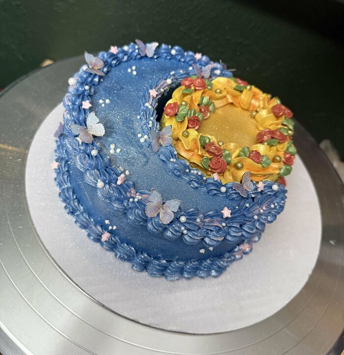 Blue and yellow decorative cake with intricate floral and butterfly designs, showcasing an incredible bake creation.