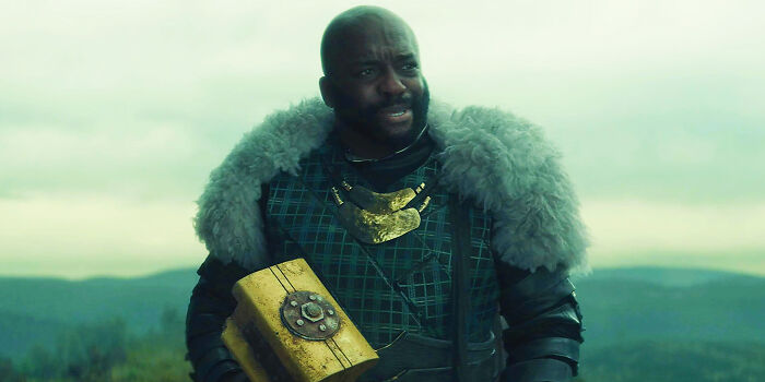 Man in medieval costume holding a golden box outdoors, one of the questionable movie details mocked by cinephiles online.