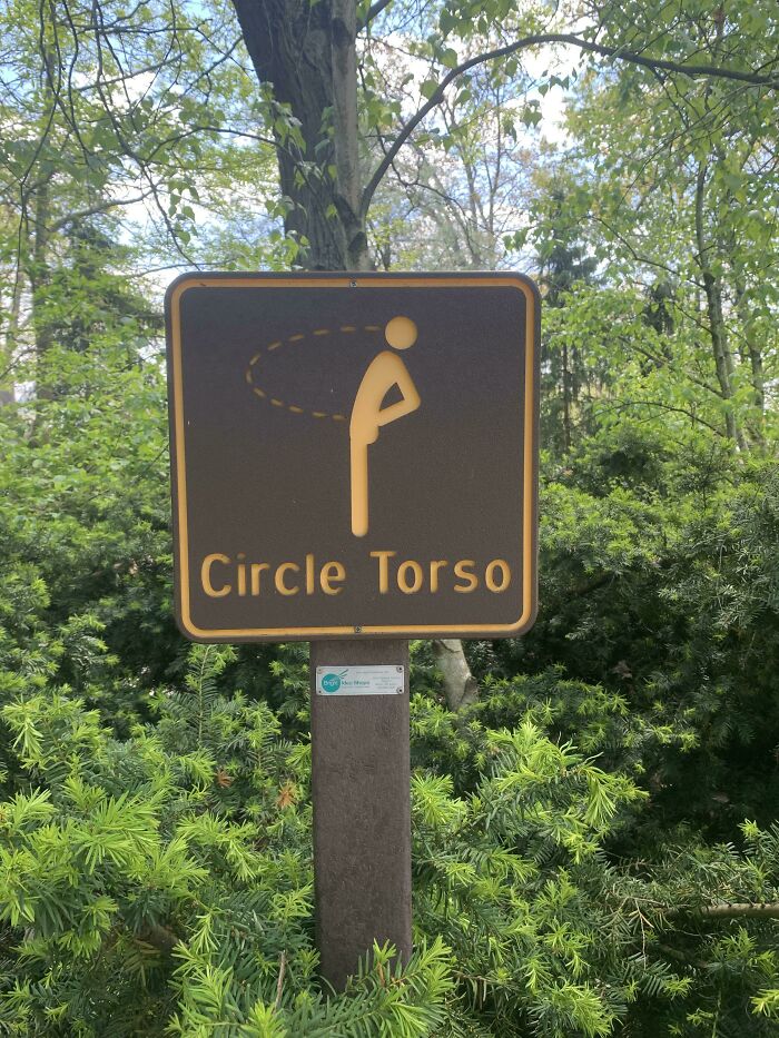 Funny signs billboard: "Circle Torso" sign with a diagram in a wooded area.