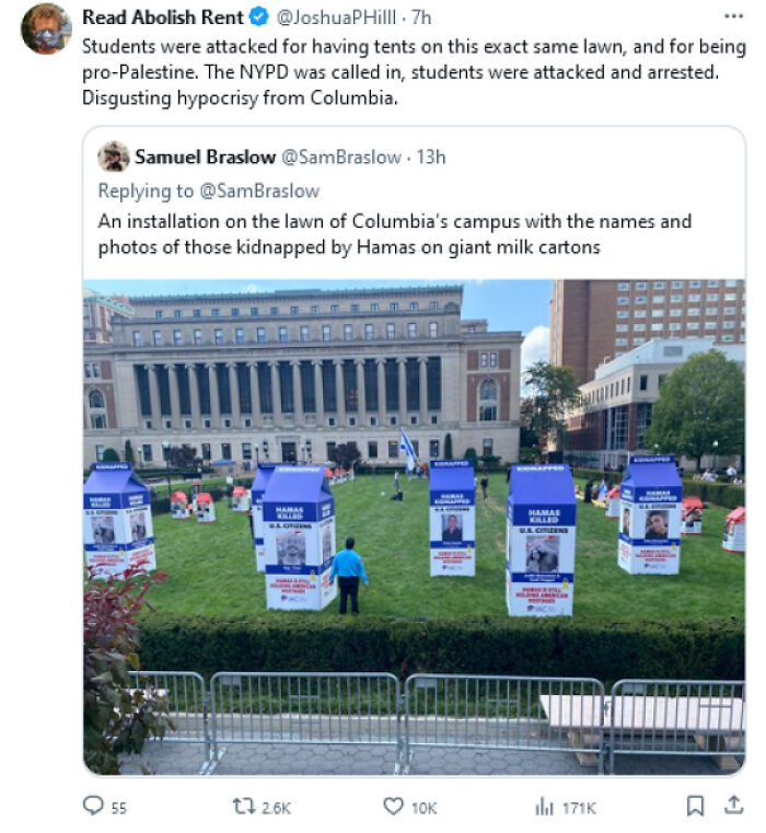 Display on Columbia campus lawn highlighting capitalism issues in America, with large signs resembling milk cartons.
