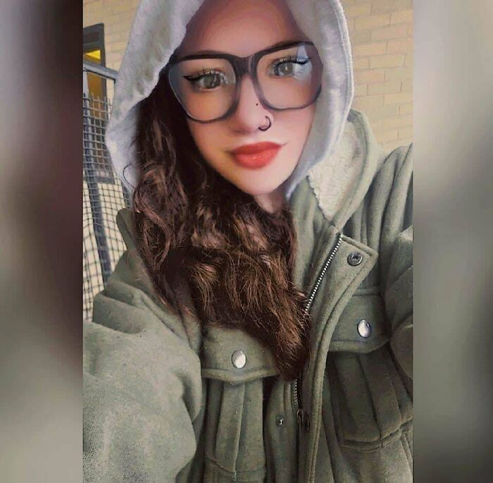 Person with digitally airbrushed face, wearing glasses and a hoodie, highlighting Instagram vs. reality effects.