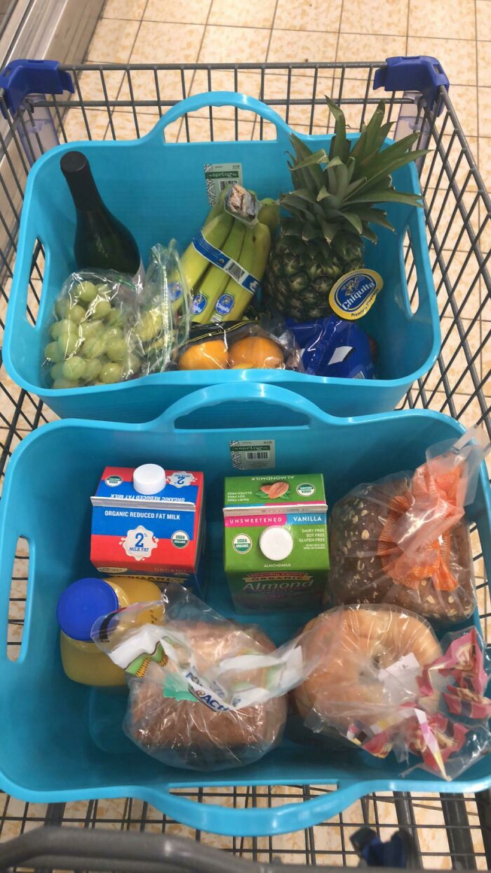 Two baskets in a shopping cart filled with groceries, showcasing grocery-shopping-hacks for efficient organization.