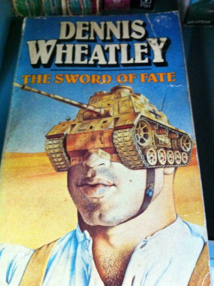 Unusual book cover with a man's head replaced by a tank, titled "The Sword of Fate" by Dennis Wheatley.