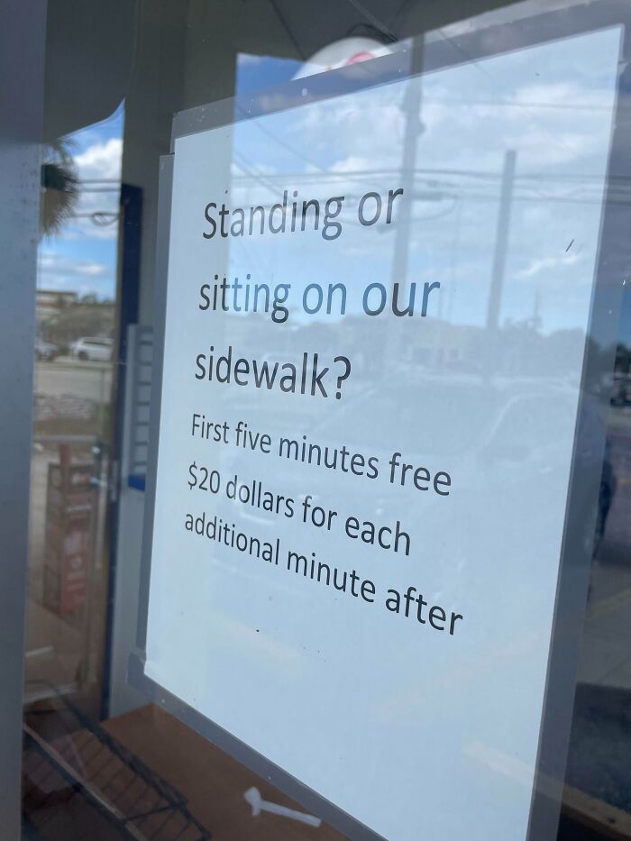 A humorous sign in Florida about charging for standing or sitting on the sidewalk.